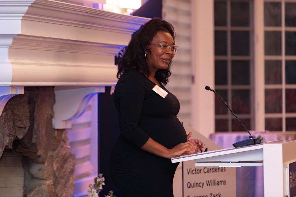 Woman talking into microphone and looking directly to crowd